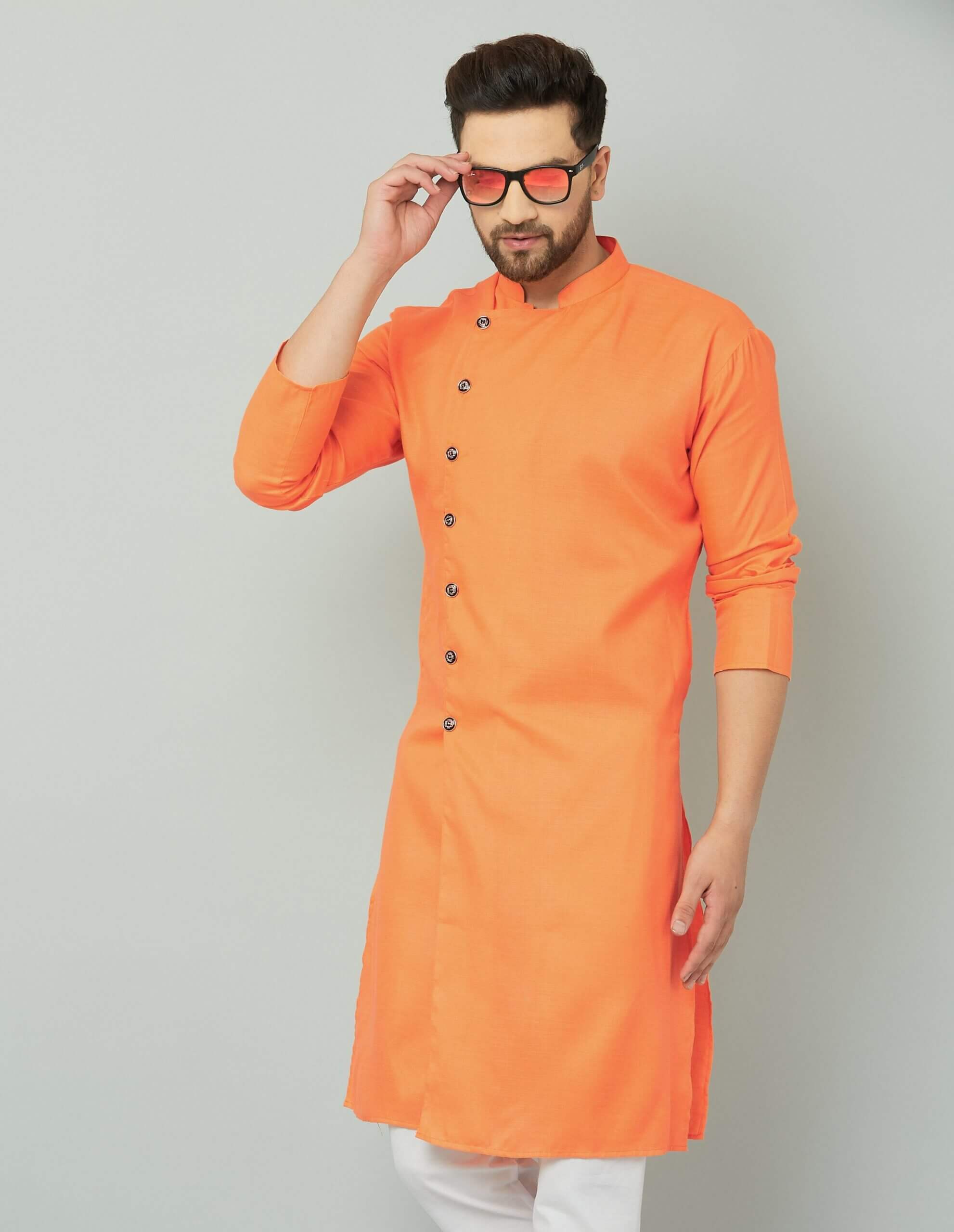 Orange cotton kurta with white pants, traditional Indian attire.