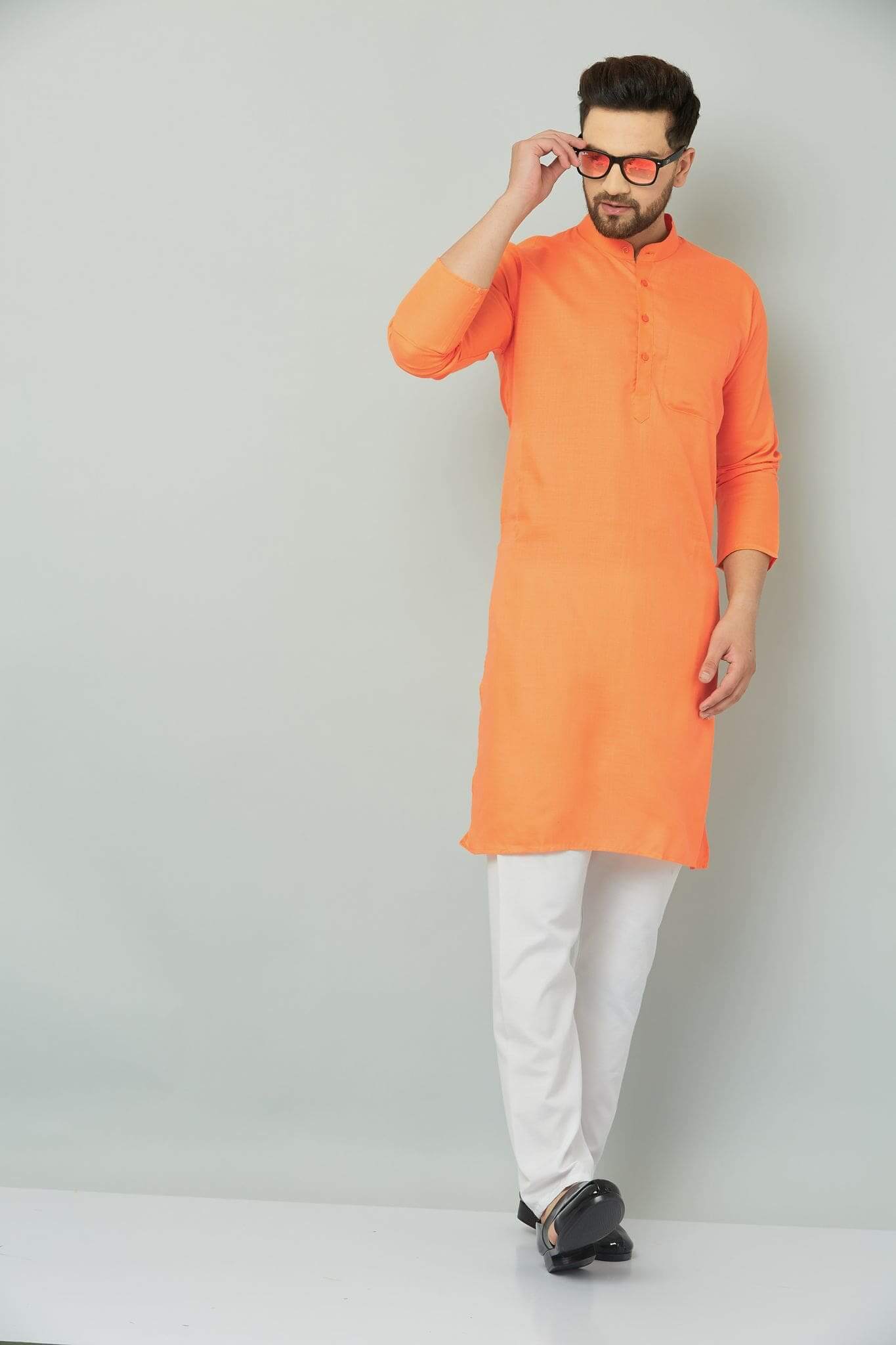 Orange kurta with intricate patterns and designs.